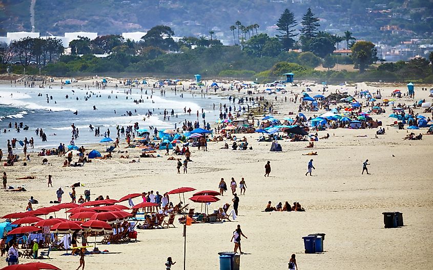 Crowds of people on the beach engaging in various beach activities, via Pamela Au / Shutterstock.com