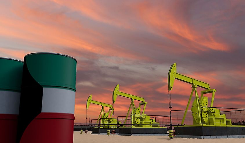 Pumpjack oil extraction and cloudy sky in sunset with the KUWAIT flag on oil barrels