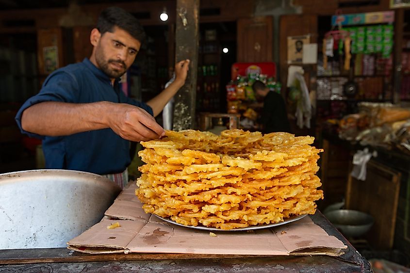 Pakistani man selling jalebi sweets on the market in Hunza Valley, Pakistan