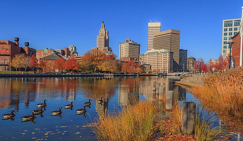 Fall Foliage in Providence, Rhode Island with buildings and ducks in the stream