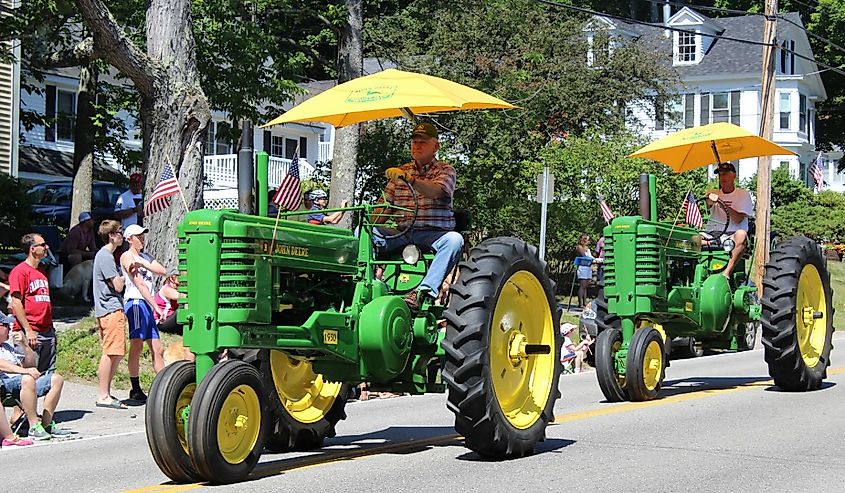 John Deere trailers drive down the main street of Wolfeboro, New hampshire.