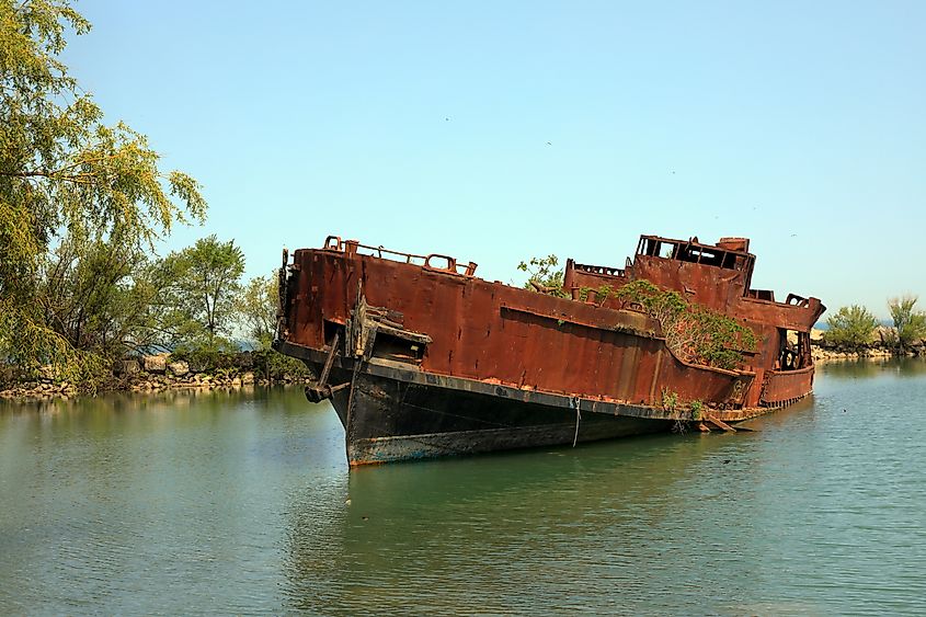The wreckage of La Grande Hermine, a relica carrack, lies abandoned and rotting in the water of Jordan Harbour near St. Catherines, Ontario