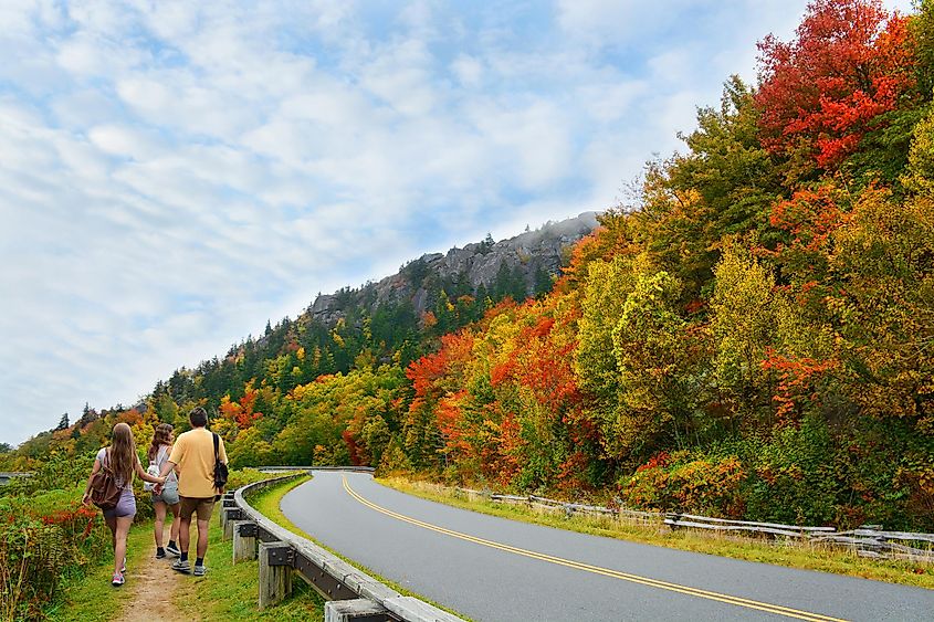 Family on autumn hiking trip enjoying beautiful views . Blue Ridge Parkway. Close to Blowing Rock, North Carolina, USA.