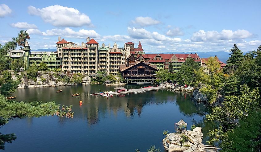 Mohonk Mountain House across a lake with a dock and small rock island in New Paltz, New York