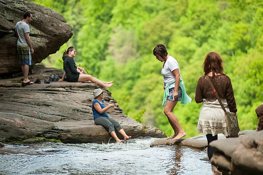 Hikers relax at the top of Kaaterskill Falls in Haines Falls, NY 