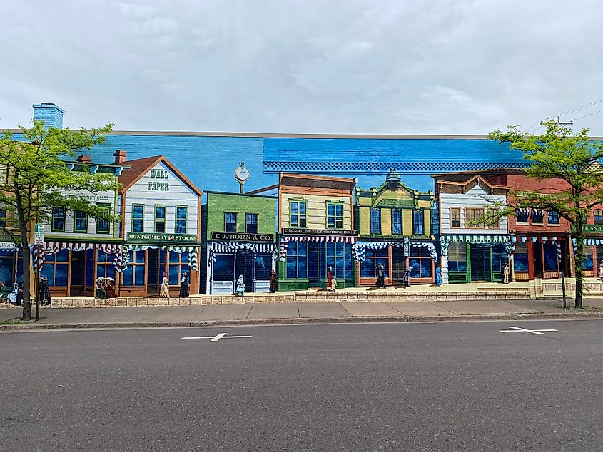 A colorful historic street mural taking up the entire side of a brick building.