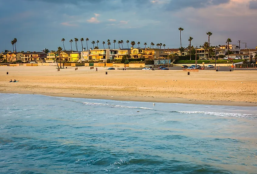 Waves in the Pacific Ocean and view of the beach at sunset in Seal Beach, California.