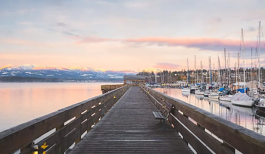 Sunset or sunrise at the waterfront boardwalk and marina on a cold winter day at Comox Harbour, British Columbia, Canada