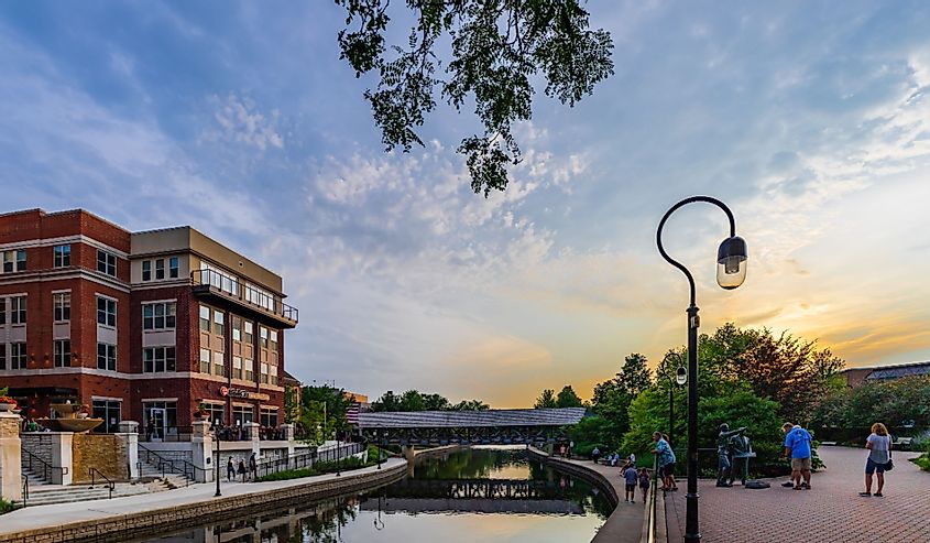 Downtown Naperville Riverwalk on a busy Saturday night features plenty of restaurants, bars, art, entertainment, and architecture