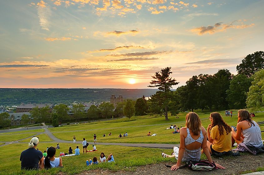 Cornell University campus, students watching sunset at Libe Slope.