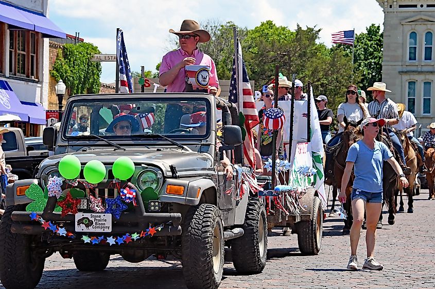 The 87th annual Flint hills rodeo parade rides through the town of Cottonwood Falls. Editorial credit: mark reinstein / Shutterstock.com