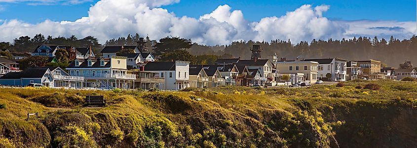 Mendocino main street shops and cliff above the sandy beach