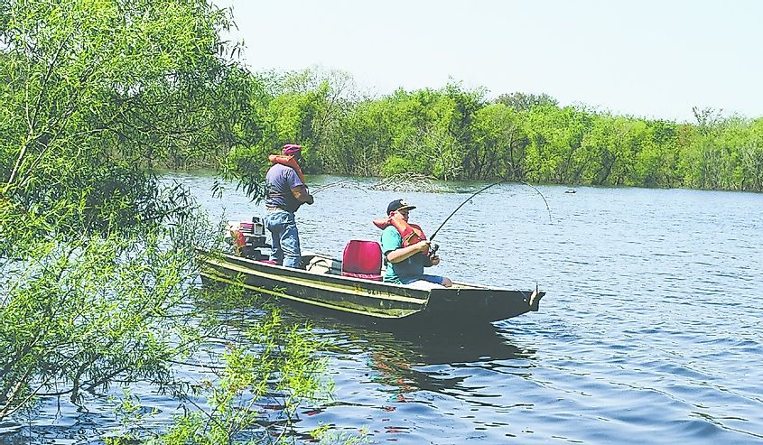 Two people fishing out of a boat on Lake Sugema