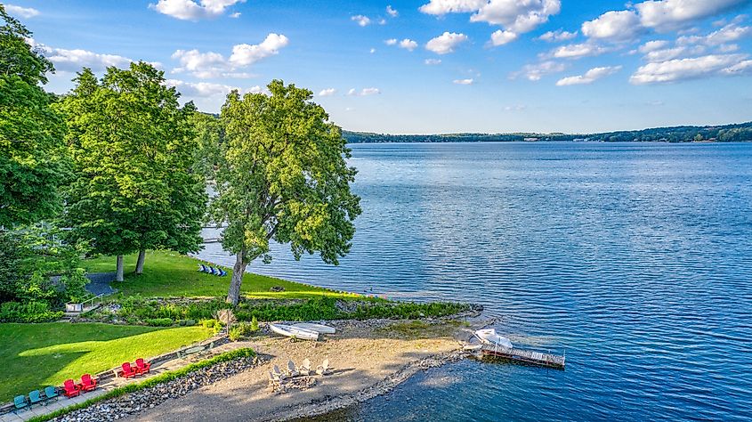 Summertime view of Keuka Lake surrounded by green trees in Hammondsport.