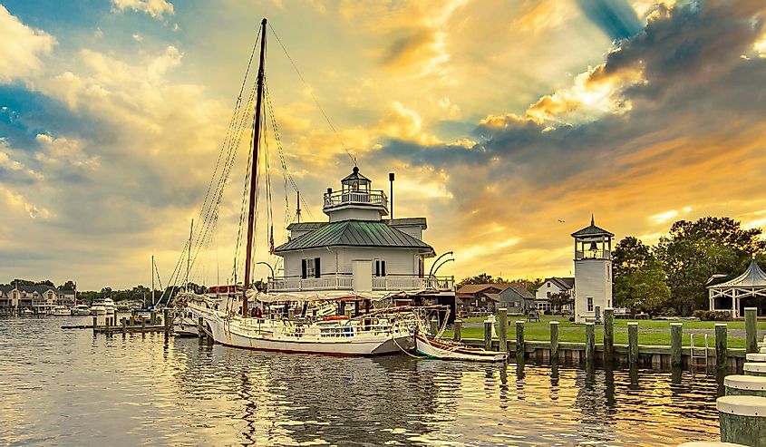 Lighthouse and boat on the dock at sunset at St Michael's, Maryland