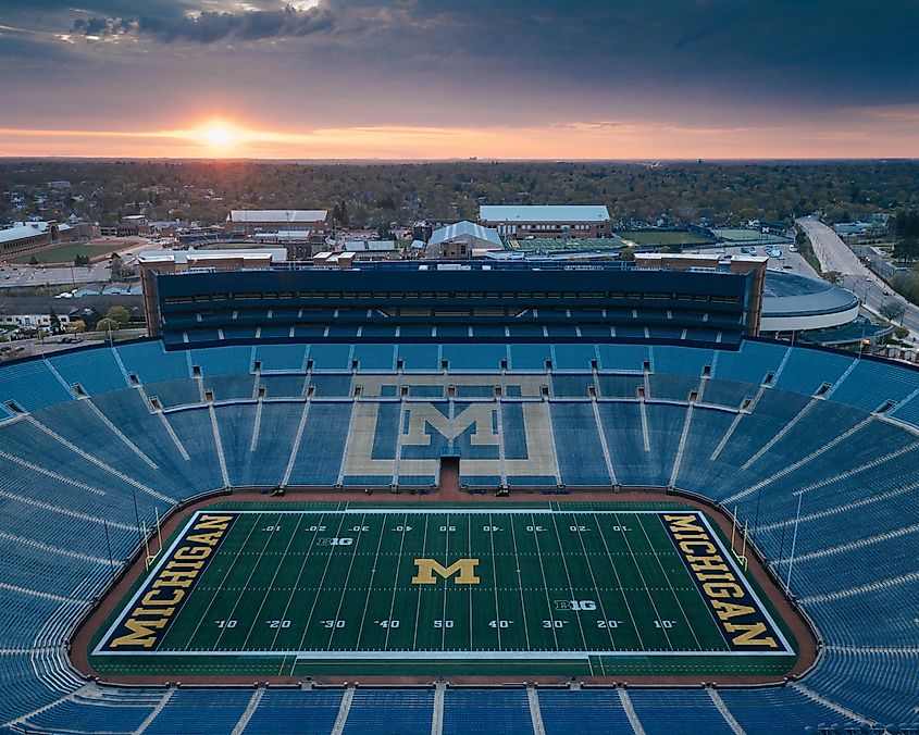 The sun rises behind Michigan Stadium. Editorial credit: Wirestock Creators / Shutterstock.com