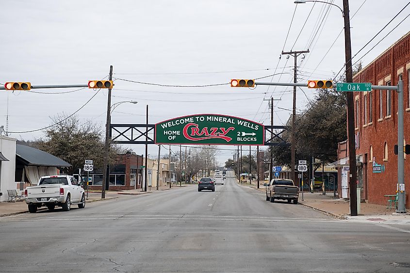 A sign over a road in Mineral Wells Texas that reads Welcome to Mineral Wells Home of Crazy