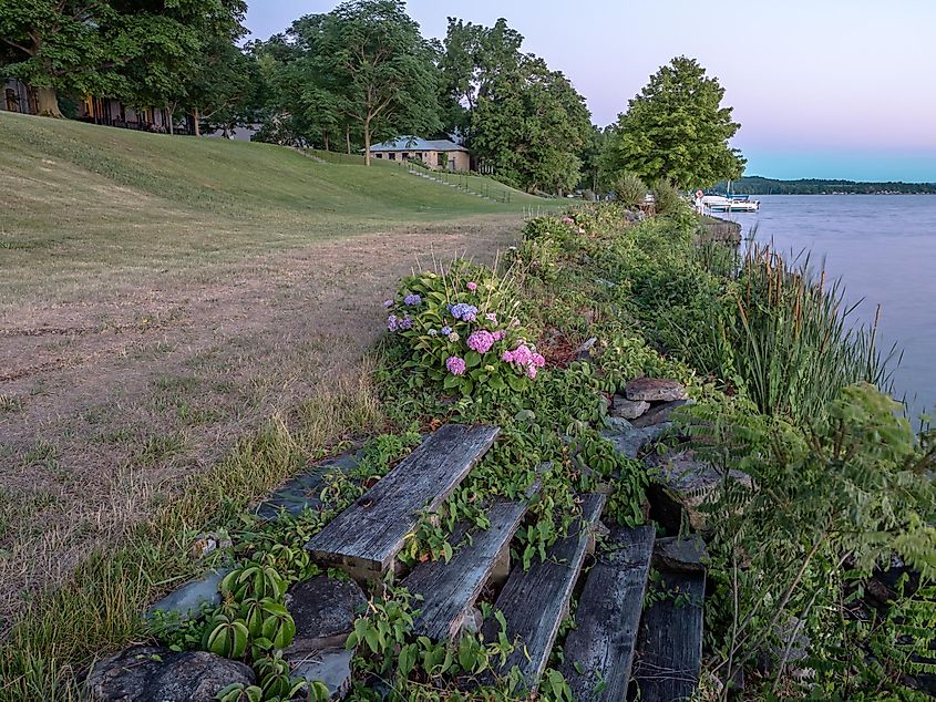 Sunset at Cayuga Lake with weathered wooden steps.