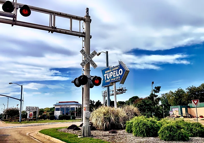 Business District sign and railroad crossing in Tupelo, Mississippi.