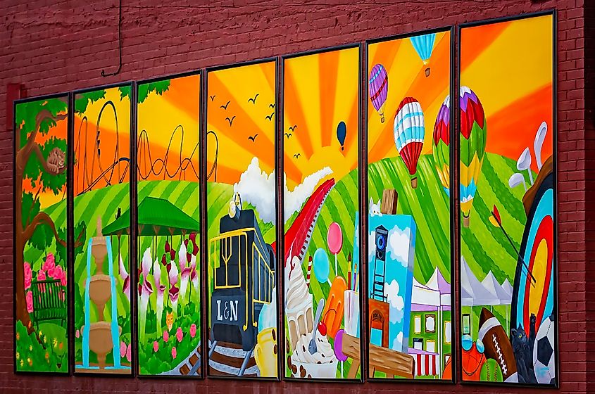 A seven-panel mural celebrates a local hotelier as well as various tourist attractions in Foley, Alabama.