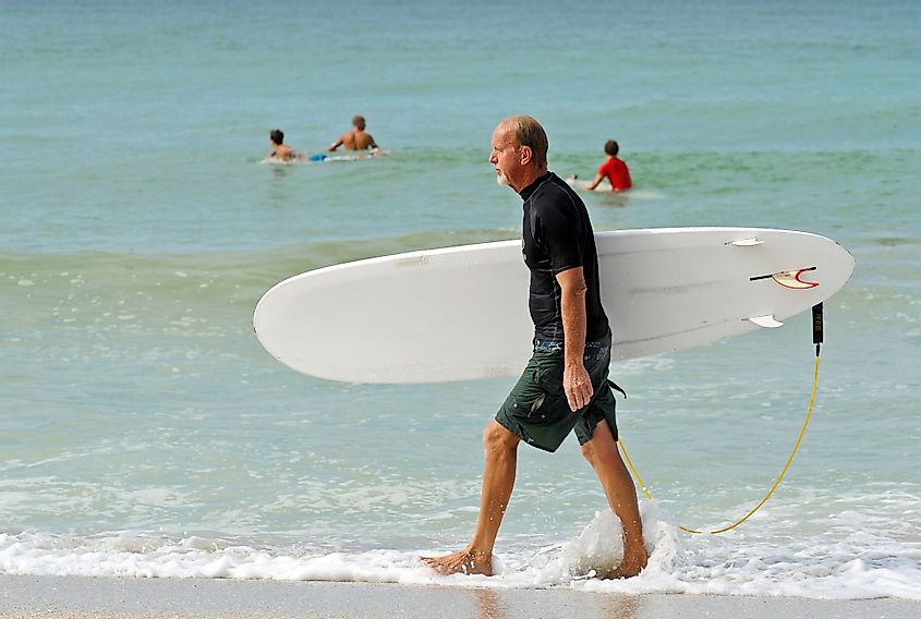 A surfer on the Holmes Beach, Anna Maria Island, Florida