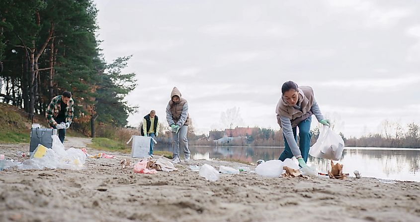 People cleaning up a lake.