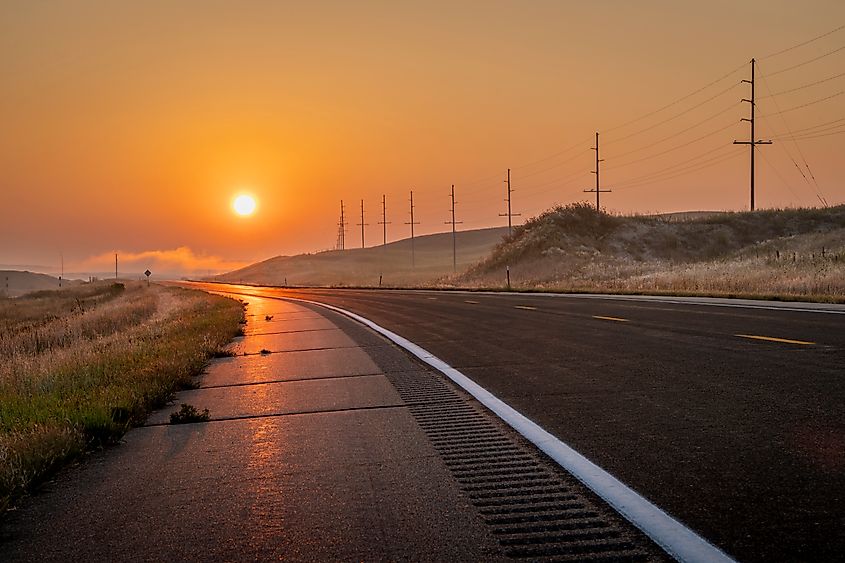 foggy sunrise over a highway in Nebraska Sandhills near Mullen.