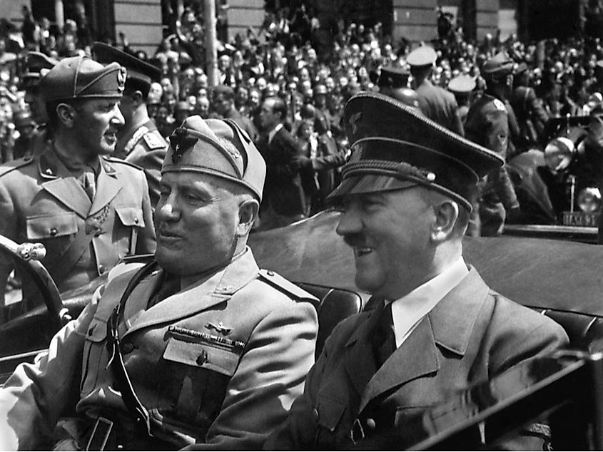 Adolf Hitler and Italian dictator Benito Mussolini riding together in a car during the 1940s, the height of the Axis alliance.