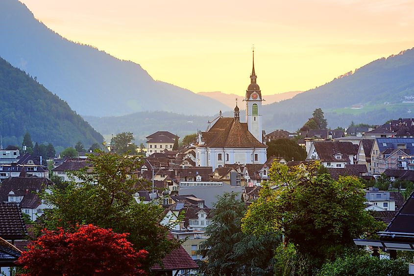 Historical Schwyz city's Old town in swiss Alps mountains in sunset light, central Switzerland.