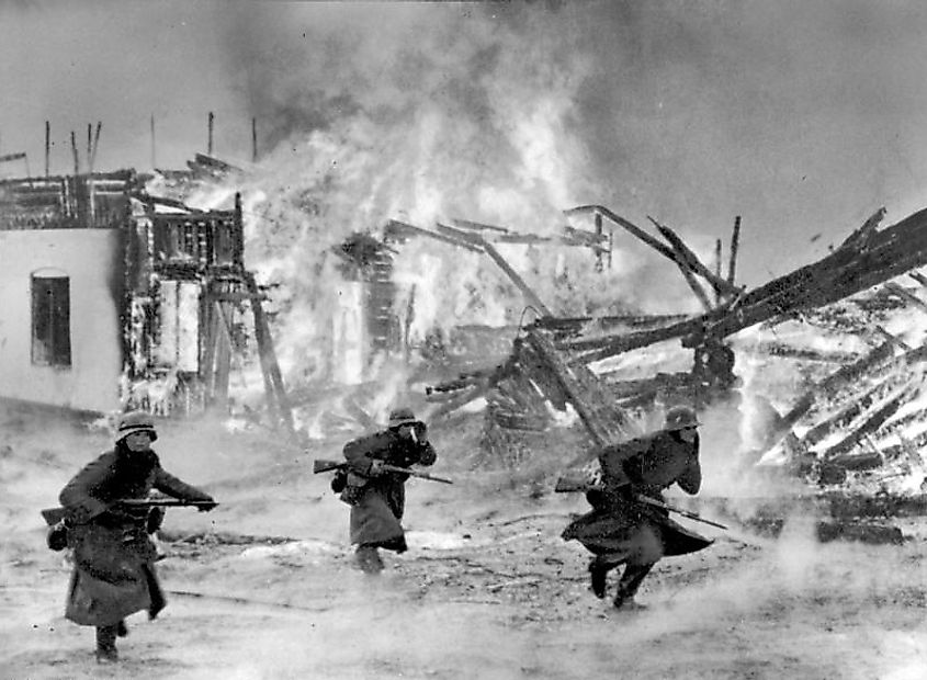 German infantry attacking through a burning Norwegian village, April 1940.