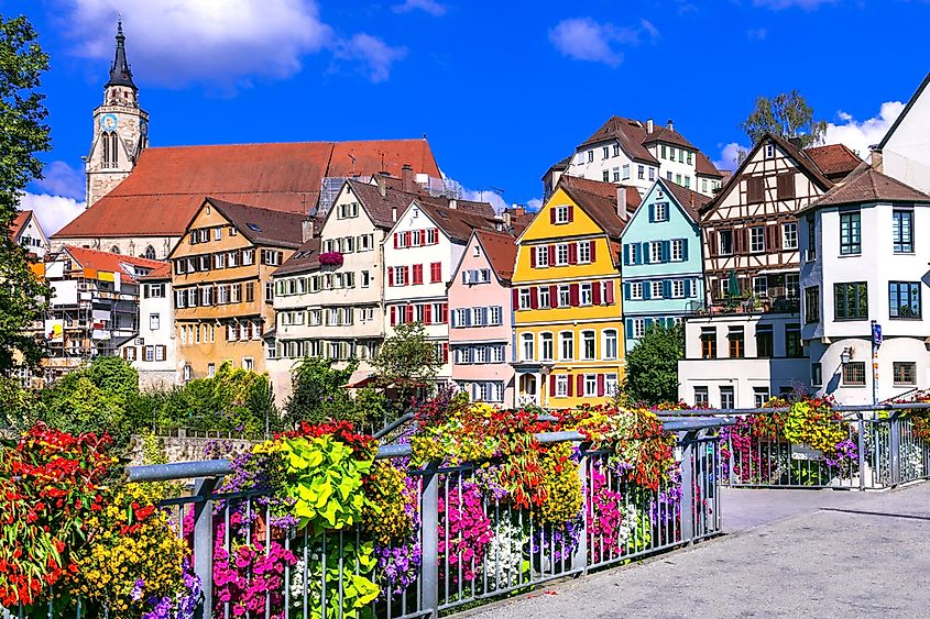 The half-timbered houses of Tübingen reflected in the Neckar River with punt boats.