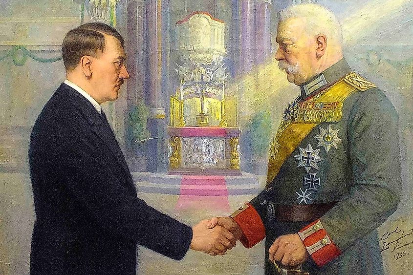 Adolf Hitler and Reich President Paul von Hindenburg shake hands in church interior, propagandistic depiction relocates Hitler's 1933 appointment as Reich Chancellor to a Protestant church.