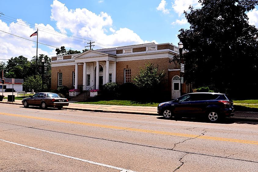 The Burlington Public Library building on the corner of North Pine and East Jefferson Streets with a blue clouded sky on a mid summer afternoon.
