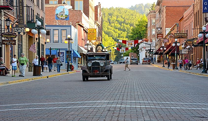 Vintage car approaching on main street in Deadwood, South Dakota.
