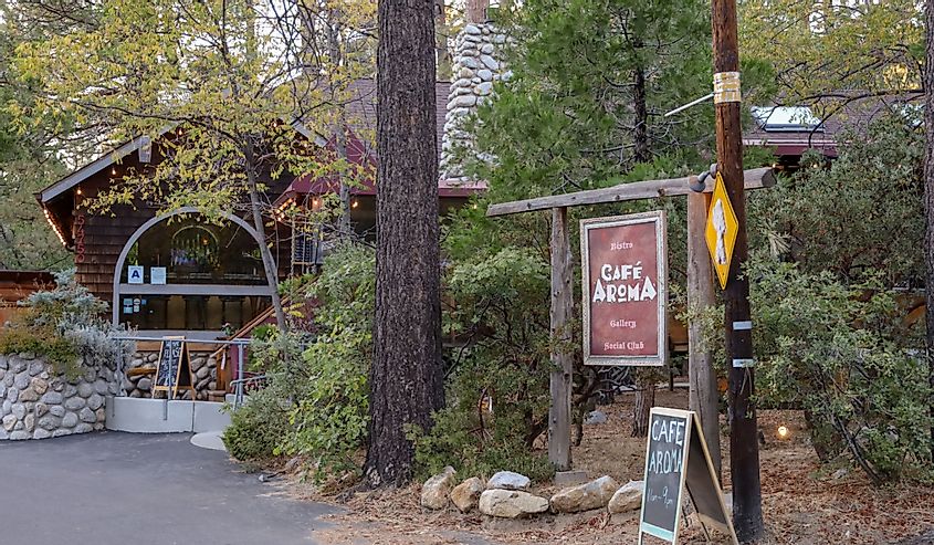 View of the Aroma Cafe restaurant and signs by the street in Idyllwild, California.