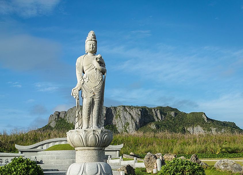 A Japanese monument at the Banzai Cliff Memorial on the island of Saipan, with the suicide cliff seen in the background. 