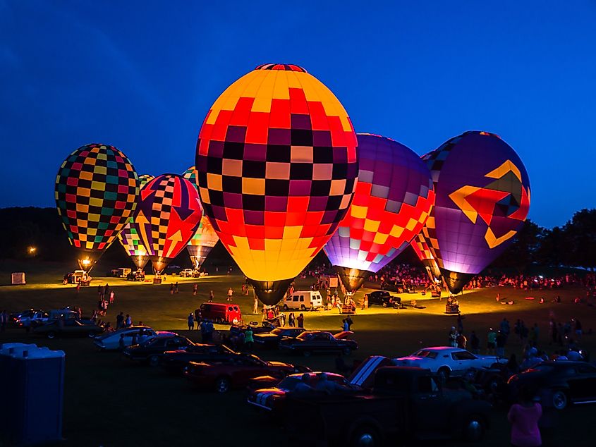 Hot air balloons illuminated at night during the Great Galena Balloon Race charity event in Galena, Illinois, supporting juvenile diabetes programs and Camp Hertko Hollow