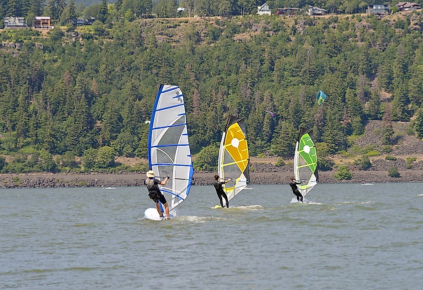 Three people wind surfing, water sports near Hood River.