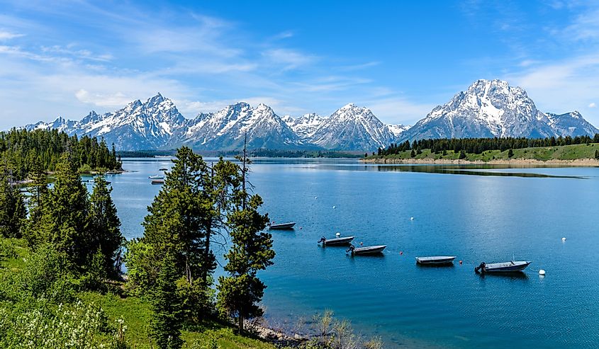 Spring view of a quiet bay of Jackson Lake, with Teton Range rising in the background, Grand Teton National Park, Wyoming