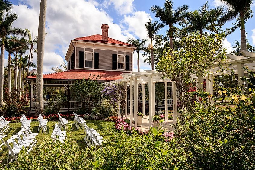 Flowers bloom in the Garden against the house at the Edison and Ford Winter Estates, via SunflowerMomma / Shutterstock.com