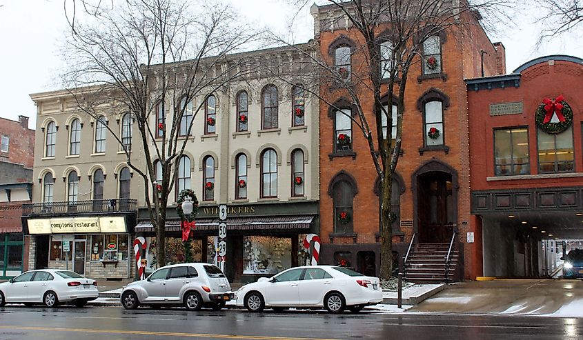 Downtown Broadway, where shops are decorated for the holidays and cars are parked along the busy street for shoppers to finish their holiday purchases.