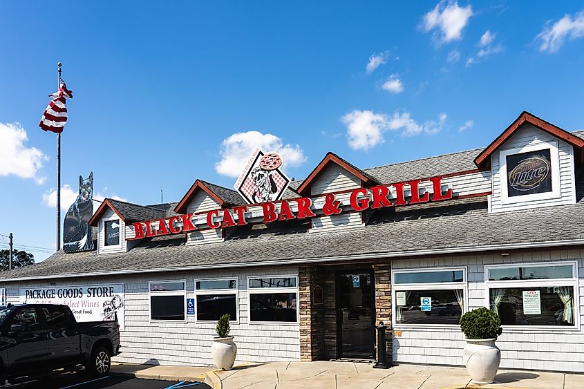 The Black Cat Bar and Grill has a sign that says "Our Chow is the Cat's Meow."