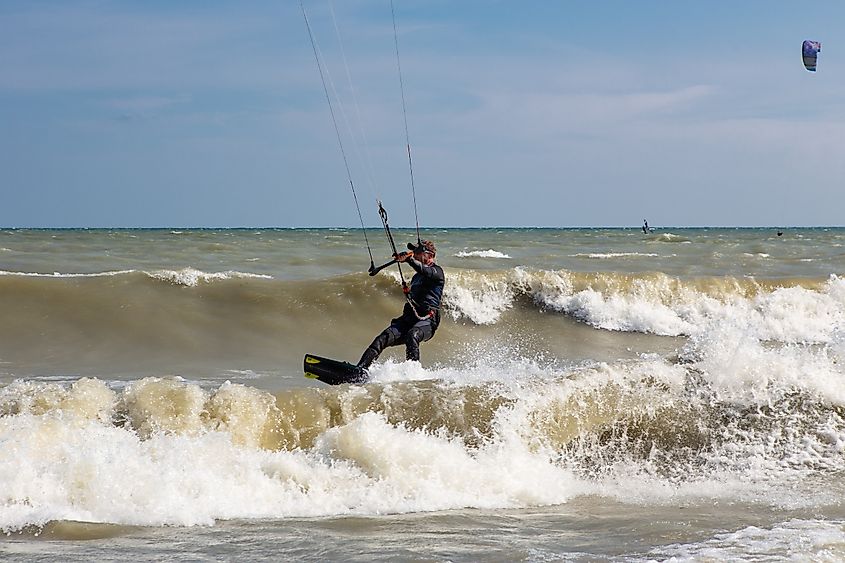 People kiteboarding in Toronto at Kew beach on Lake Ontario on a windy day