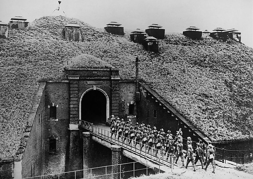 British troops march over bridge into the French underground fortress covered with vegetation, 1939..
