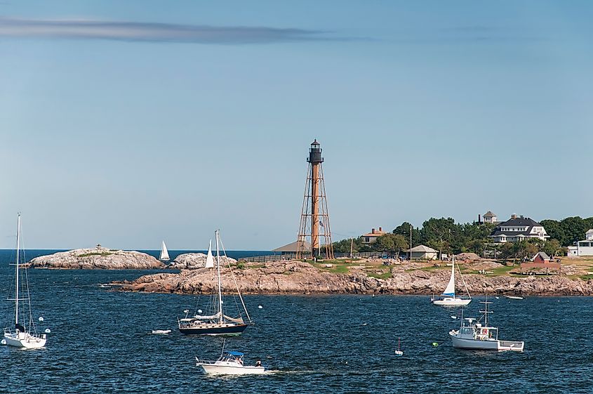 Boats moored offshore near Marblehead Lighthouse in marblehead Massachusetts.