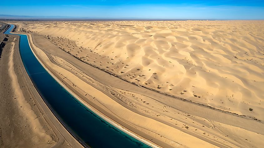 Dramatic aerial view of the all-American canal traveling through the Buttercup sand dunes in imperial county California.