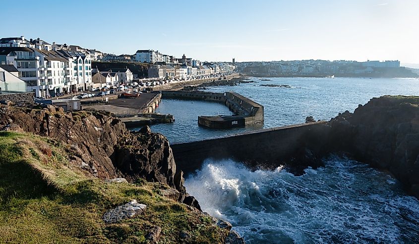 Waves crashing up against the seawall at the harbour in Portstewart Northern Ireland