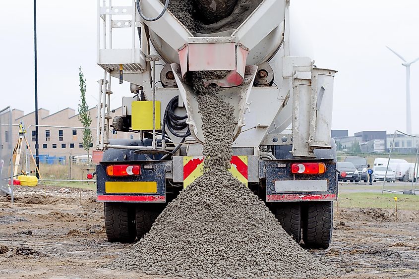 Ready-mix semi-dry concrete delivered on construction site and discharged from the mixing truck