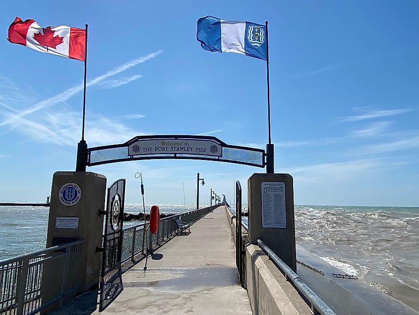 A Canada flag and a local flag marks the entrance to the Port Stanley Pier, met today by choppy Lake Erie waves.