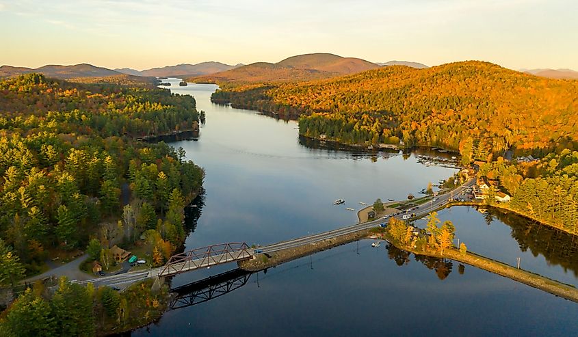 The leaves are changing in autumn along the lake and on the mountaintops at Long Lake